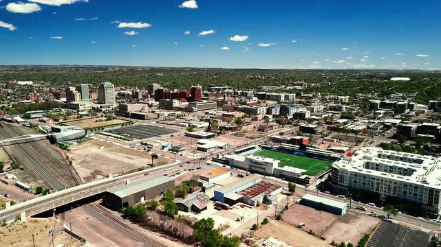 Drone flying forward over downtown Colorado Springs revealing modern city blocks and grid layout