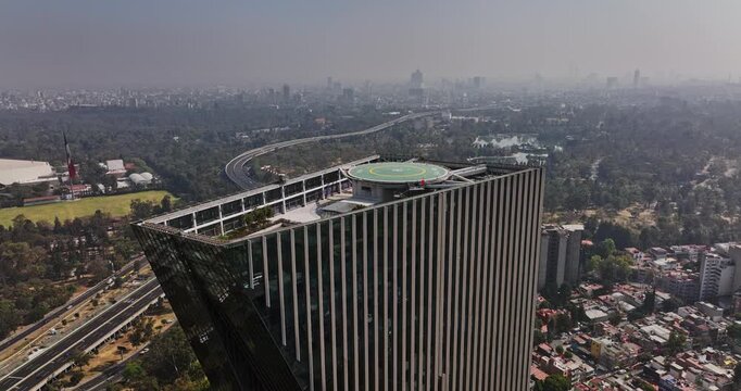 Mexico City Aerial v86 cinematic flyover skyscraper torre virreyes reveals urban landscape of bosque de chapultepec park and cityscape along the skyline - Shot with Mavic 3 Cine - January 2022
