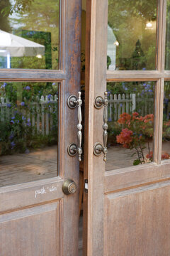 Close up of wooden door with classic golden handles and ornaments,gold door handle and lock,Beautiful entrance to an expensive home or Luxury hotel,Copy space.