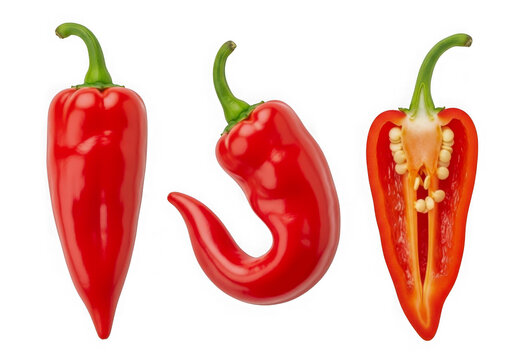 Three fresh red chili peppers whole and sliced showing seeds on a kitchen table isolated on transparent background
