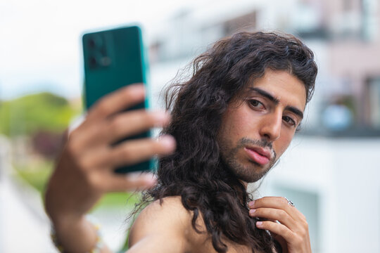 Middle Eastern man with vitiligo taking a selfie outdoors