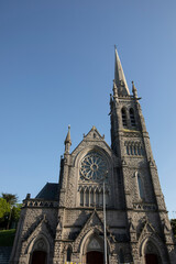 Fototapeta premium Afternoon sun illuminates a historic church in the city centre of downtown Drogheda, County Louth, Ireland.