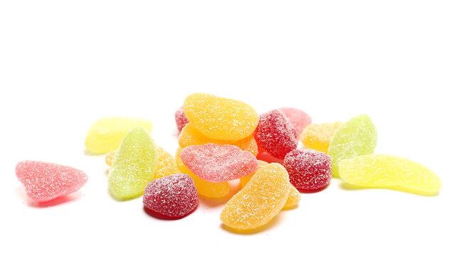 Colorful jelly fruit candies, candy pile isolated on white background, side view