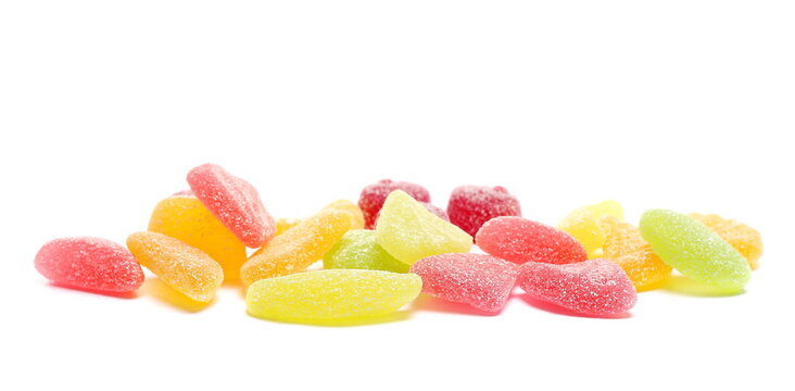 Colorful jelly fruit candies, candy pile isolated on white background, side view