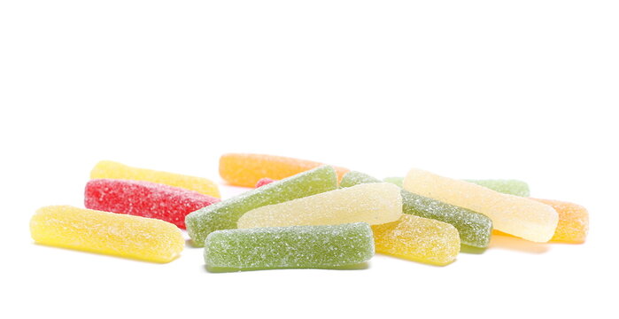 Colorful jelly fruit candies, candy pile isolated on white background, side view