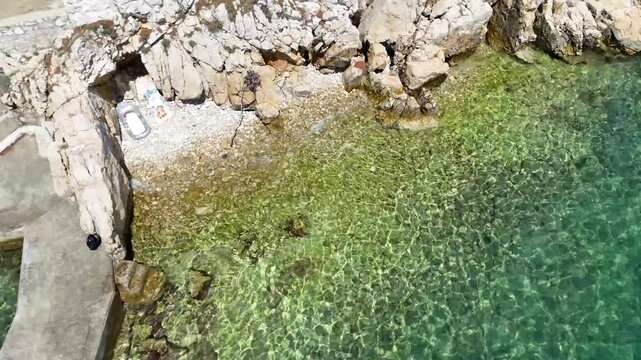 Aerial sea surf. Clear water shore. Turquoise ocean wave. Rocky beach coastline.