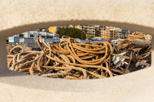 Coiled maritime rope and debris framed at Calpe beach