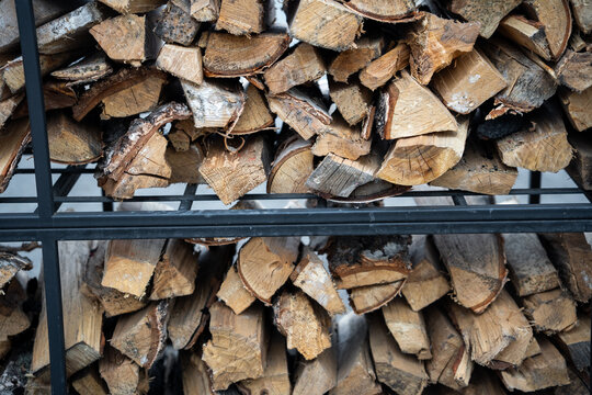 Neatly stacked firewood in a sturdy metal rack