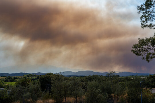 Pyr&eacute;n&eacute;es-Orientales, France, July 5, 2026: Smoke from the Tr&eacute;villach wildfire spreads over Mediterranean hills and wooded vegetation near Perpignan during a major wildfire in southern France.