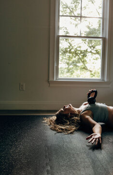 Woman lying with kettle bell weight on chest