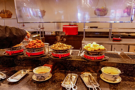 Vietnamese hot pot buffet counter with steaming dishes