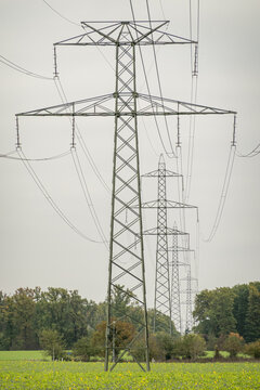 High voltage transmission towers crossing rural landscape