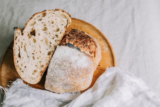 Rustic artisan bread loaf with organic ingredients on board