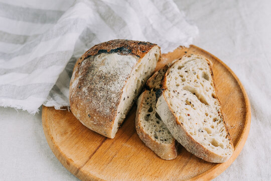 Rustic artisan bread with organic ingredients on board