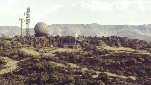 A remote landscape features a radar station surrounded by rocky terrain and greenery. Towering mountains rise majestically in the background, embraced by gentle clouds and a calm atmosphere.