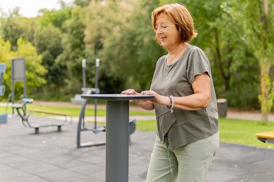Senior woman doing outdoor fitness workout in park