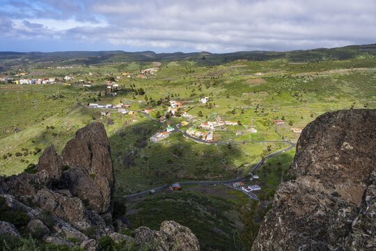 View from the Fortaleza de Chipude table mountain of the houses in the village of La Dehesa and the surrounding countryside. During the day, good weather. La Gomera, Canary Islands, Spain