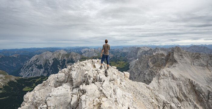 Hiker at the summit of the Birkkarspitze, Hinterautal-Vomper chain, Karwendel, Tyrol, Austria