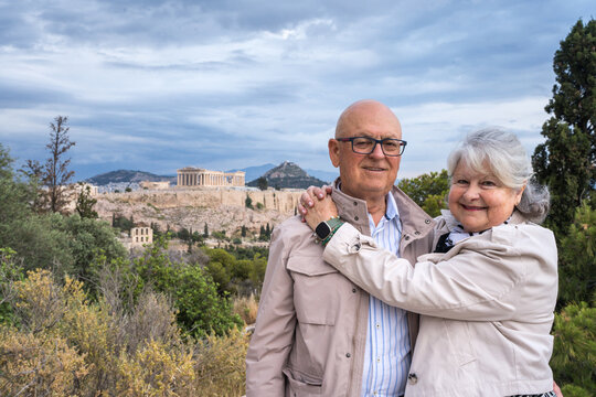 Senior couple hugging with Athens Acropolis in background