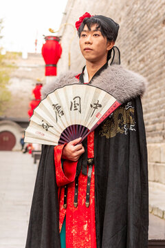 Male in traditional hanfu at Xi&rsquo;an City Wall with fan