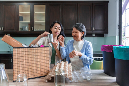 Asian family sorting household waste for recycling at home