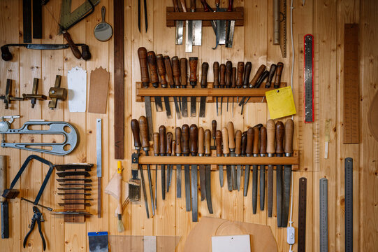 Tools neatly organized on a wooden workshop wall