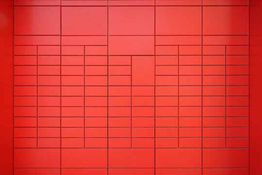 Red geometric tiled wall background with modern grid pattern