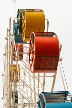 Colorful observation wheel cabins on amusement park ride