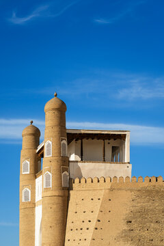 Ark of Bukhara fortress walls and towers under blue sky