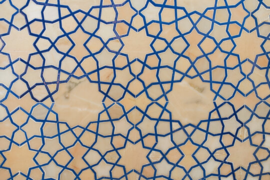 Islamic geometric tile pattern in blue on beige background