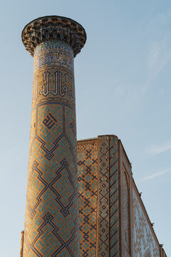 Ornate mosaic minaret at Registan square, Samarcanda