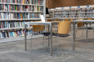 Study table with chairs in a quiet modern library © Olha Semeniv