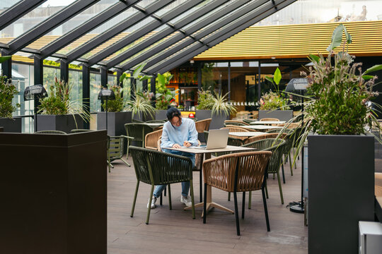 Businesswoman working remotely in a modern outdoor setting