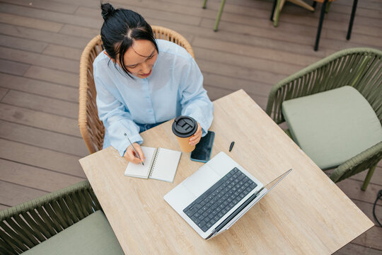 Asian businesswoman working at outdoor cafe