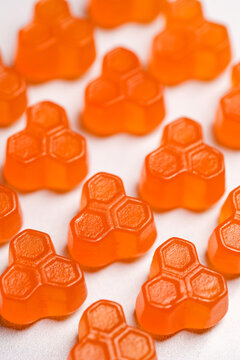 Food supplements. Orange vitamins jelly gummies on bright background