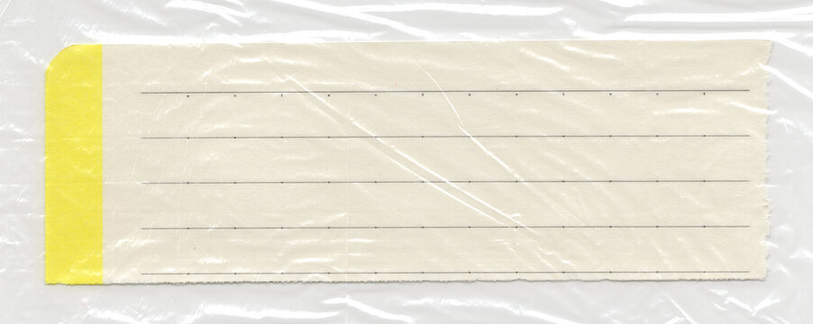Polyethylene film texture wrapped over a narrow cream lined tag with a yellow edge marker provides a realistic glossy overlay for alternative typography placement in street style graphics