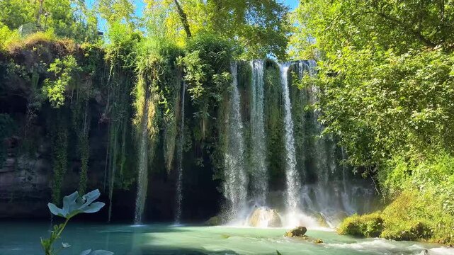 Duden waterfall cascading over rocky cliffs surrounded by lush green forest in Antalya, Turkey