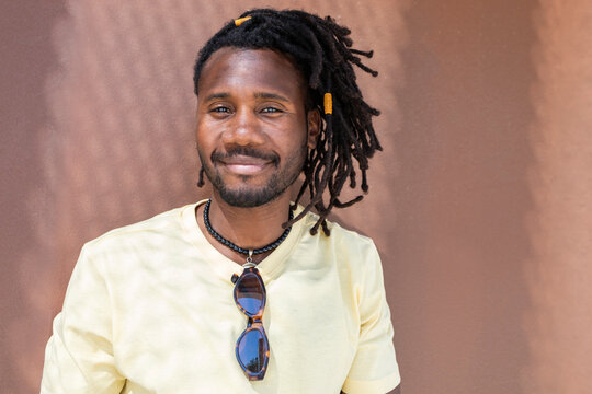 Cuban man with dreadlock hairstyle smiling in portrait