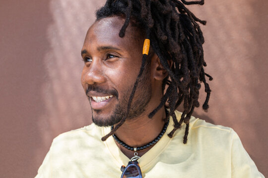 Smiling Cuban man with dreadlocks in outdoor portrait