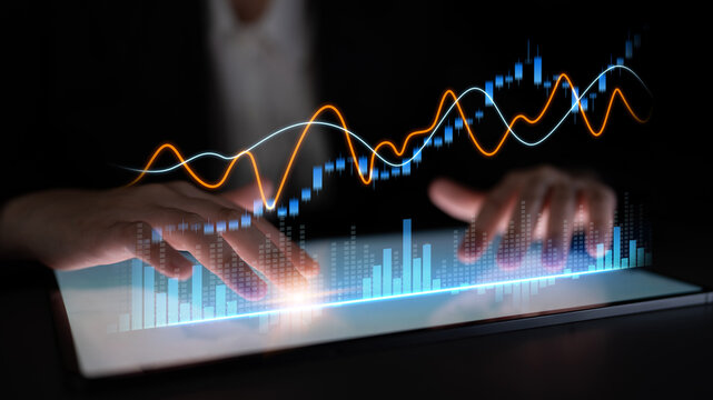 A close-up of hands interacting with a sleek touchscreen that showcases vibrant digital graphs and data analysis, symbolizing innovation in financial technology. Scalp
