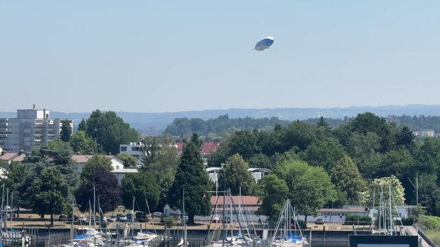 Friedrichshafen, Germany - June 27, 2026: A Zeppelin airship flying over the city and Lake Constance. Friedrichshafen is closely associated with Zeppelin airships and aviation history.
