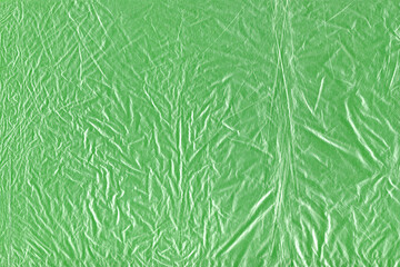 Obraz premium Crumpled wrapping film forms a tactile distressed backdrop for collage layers, packaging mockups, scrapbook accents and experimental artwork needing creases, reflective folds and raw surface detail
