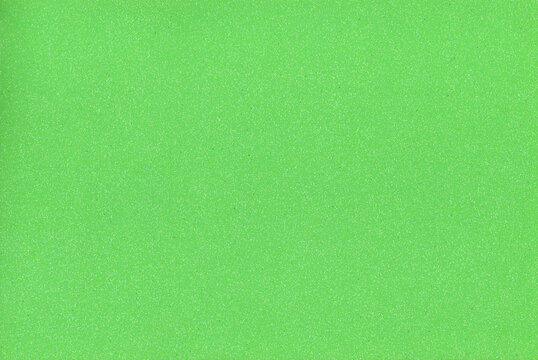 Craft foam sheet texture fills the screen completely to provide a solid green background for scrapbooking projects and artistic material backdrop cutouts used in creative handmade layouts