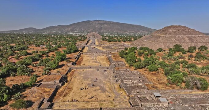 Teotihuacan Mexico Aerial v8 low level flyover and around archaeological site, panning above avenue of the dead capturing historic pyramid and temple - Shot with Mavic 3 Cine - December 2021