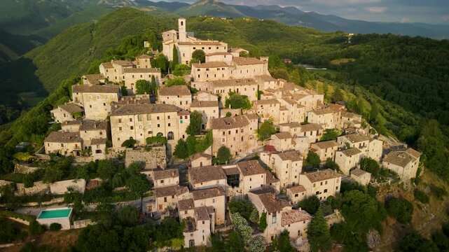 Labro Rieti Italy 4K Drone. 70mm telephoto sunset flight authentic medieval hilltop village pyramid shape panorama. Cinematic valley Sabina mountains wilderness aerial video Hidden Gems