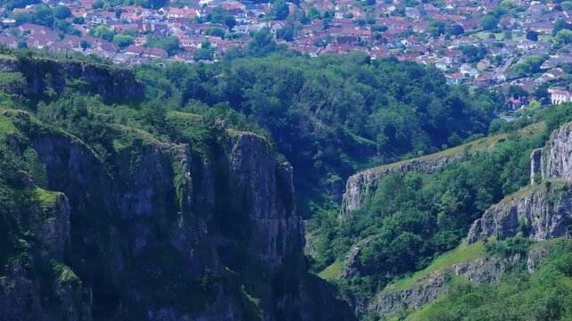 Tracking telephoto aerial shot of Cheddar Gorge, Somerset, UK