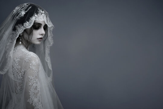 Melancholic ghost bride in vintage lace wedding veil looking down with haunting elegance, ethereal gothic portrait, supernatural romance concept with copy space