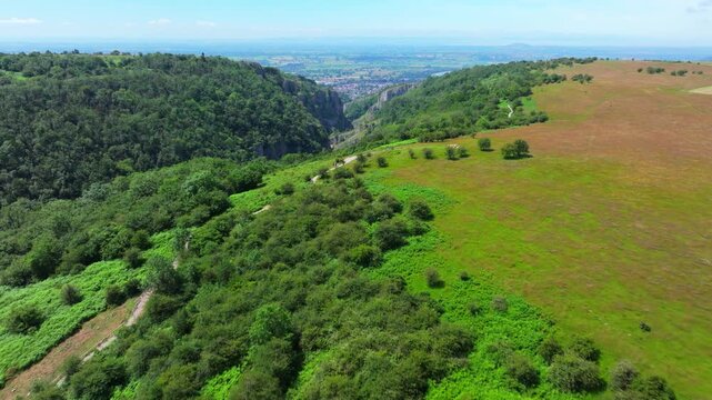Aerial drone shot flying over Cheddar Gorge on a sunny day. Somerset, UK