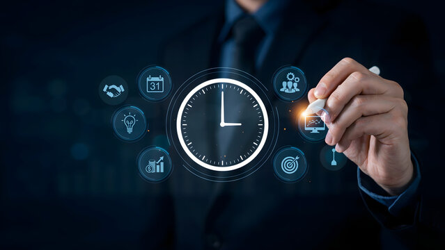 Businessman in a dark suit using a digital pen to interact with a glowing clock and various business management on a dark background