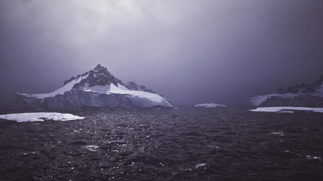 Dense fog approaching icy island outline, pale diffuse sun through haze, muted sea surface and soft edges scouting team imagined on lookout conducting early